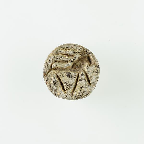 Rosette Stamp Seal with Striding Lion · ca. 1200–945 BCE · Glazed steatite